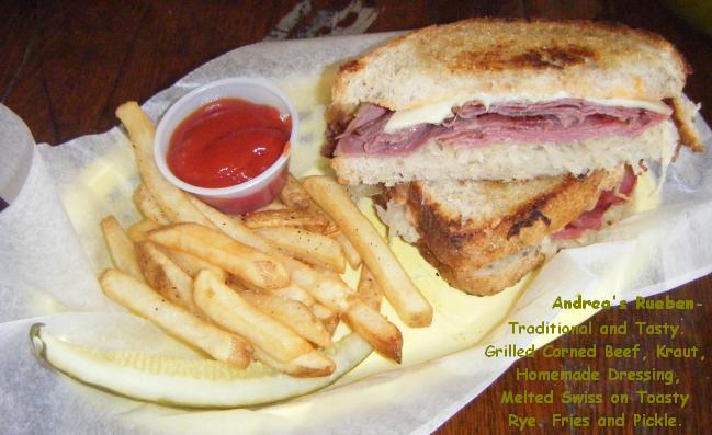 Andrea's Rueben- Traditional and Tasty. Grilled Corned Beef, Kraut, Homemade Dressing, Melted Swiss on Toasty Rye. Fries and Pickle.